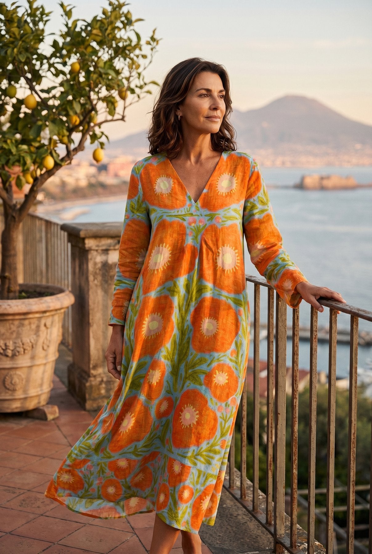 The Sylvia Cocktail Dress in orange and cream retro floral, full-body editorial on a Sorrento terrace at golden hour