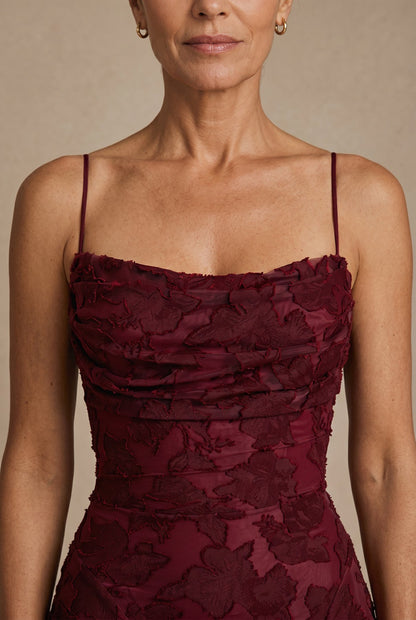 The Cynthia Ceremony Dress in cherry burgundy, close-up of the ruched cowl bodice and burnout lace detail