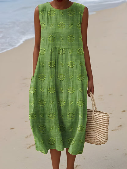 The Frances Cruise Dress in fern green textured linen, coastal beach setting